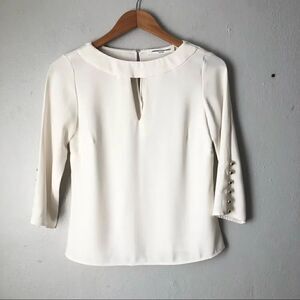 Amanda Uprichard cream colored blouse with gold button sleeves size small